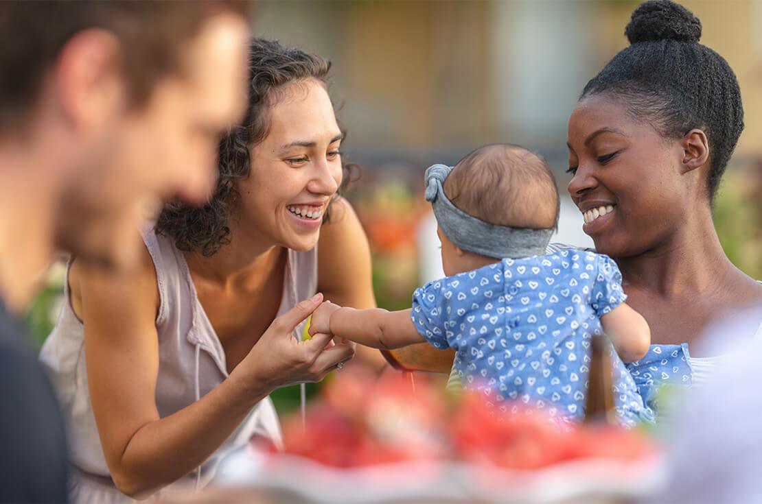 Friends playing with baby